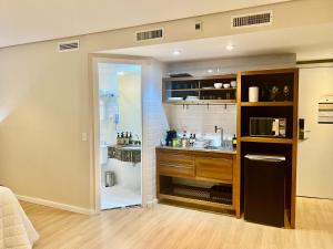 a small kitchen with a sink and a shower at Radisson Premium Faria Lima in Sao Paulo