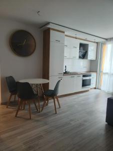 Mieszkanie w centrum Tarnowa 2.0 في تارنوف: مطبخ مع طاولة وكراسي في غرفة