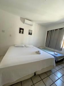 מיטה או מיטות בחדר ב-Pousada Aconchegante - Suíte