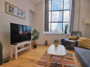a living room with a large flat screen tv at Shard View Apartments in London