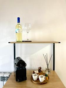 a table with a bottle of wine and a glass at 4Rooms in Palermo