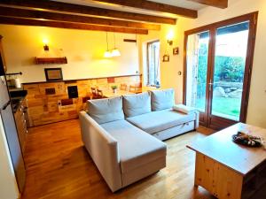 a living room with a white couch and a table at Peace & Rest in Pirineus in Latour-de-Carol