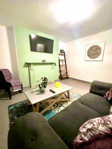 a living room with a couch and a table at Cambridge Heritage Apartments in Cambridge