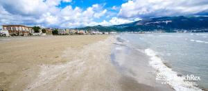 a view of a beach with buildings and the ocean at villa Heljos apartaments in Vlorë