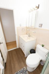 a bathroom with a white toilet and a sink at Charming 2-Bed Apt Mins from NYC - Sleeps 7 in Union City