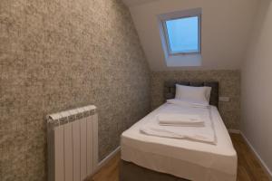 Letto o letti in una camera di Tara Lux apartmani