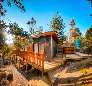 a tiny house with a deck and a bench at Cabañas Boutique Faldeos de La Lajuela in Santa Cruz +28 photos