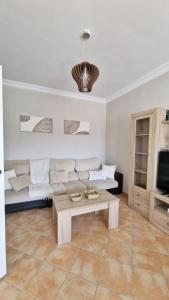 a living room with a couch and a coffee table at Villas Luins in Chiclana de la Frontera