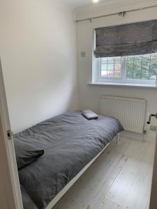 a bed in a small room with a window at Casa Elisa in Enfield