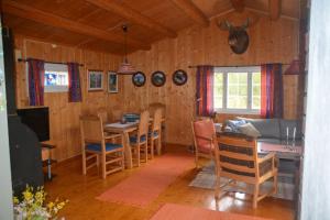 a living room with a table and a dining room at Einkjerrbu cabin by Norgesbooking - in Svingvoll