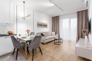 a living room with a table and a couch at Warsaw View Prestige Apartment in Warsaw