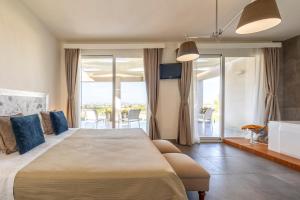 a bedroom with a large bed and a balcony at Villa Kalòn Sicily with private pool sea view in Marsala +30 photos