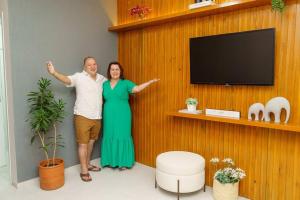a man and a woman standing in a room at O Recanto M&M na Praia de Fora. in Palhoça