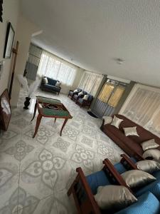 a living room with a couch and a table at Finca Santa Lucia, Anolaima in Anolaima