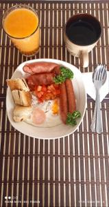 a plate of food with sausage and carrots on a table at Hermosa casa ubicada en la playa in Termales - agua caliente - nuqui