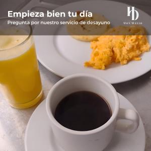 a cup of coffee and a plate of food at Don David Sabana Hotel in Sabana de Torres