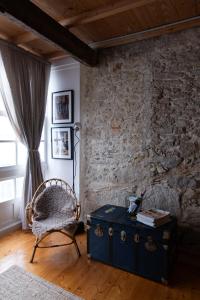 a room with a blue chest and a chair and a window at Cosy flat, heart of the city in A Coruña