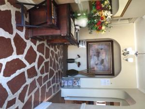 a kitchen with a stone wall and a picture on the wall at Villa Valencia in Pinetown