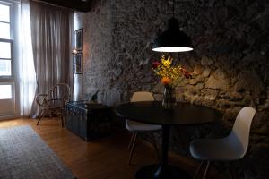 a dining room with a table with flowers and a lamp at Cosy flat, heart of the city in A Coruña