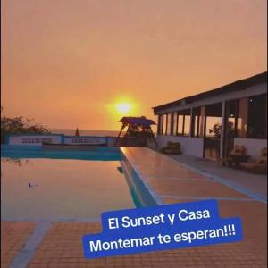 a swimming pool with the sunset in the background at Casa Montemar Hotel-San Vicente in San Vicente
