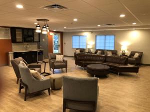 a large living room with couches and chairs at Candlewood Suites Fort Wayne - NW by IHG in Fort Wayne