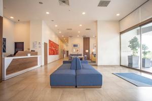 a large living room with a blue couch at Holiday Inn Express Guadalajara Iteso, an IHG Hotel in Guadalajara