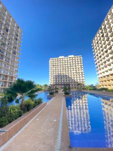 two tall buildings next to a swimming pool at Saekyung Village1, Phase 3, Marigondon, Lapu-Lapu City, Cebu in Lapu Lapu City