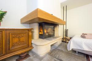 a fireplace in a room with a bed and a bed sidx sidx sidx at Exclusive House in Old Town in Tallinn