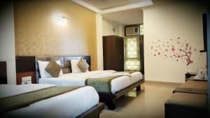 a hotel room with two beds and a window at Hotel Delhi Aerocity, NH 8 in New Delhi