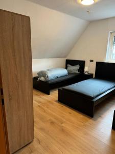 a room with two beds and a mirror at Schöne Wohnung mit TV, WLAN und Küche - Anna in Werne an der Lippe