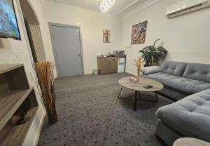 a living room with a couch and a table at استيديو حياة الفيصلية دخول وخدمة ذاتيه in Al Rass +2 photos