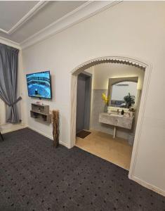 a living room with a mirror and a sink at استيديو حياة الفيصلية دخول وخدمة ذاتيه in Al Rass