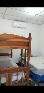 two bunk beds in a room with a ceiling at Hostel Caballo Blanco in Moyogalpa