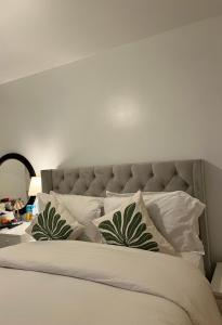 a bedroom with a bed with white pillows at Luxury Kingdom in Redbridge