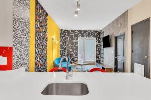 eine Küche mit einem Waschbecken und farbenfrohen Wänden in der Unterkunft Color Splash Pad!! in Arlington