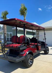 a red golf cart with a red roof at Minutes to Beach ,Golf Cart Included, Ocean View Pool ,Beach Equip, Ocean Therapy in Saint Joe Beach