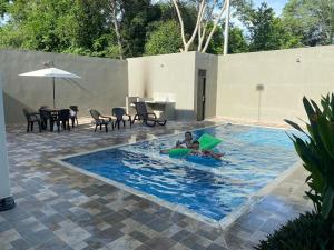 a child is playing in a pool in a backyard at Casa Campestre para Descansar Girardot in Flandes +8 photos