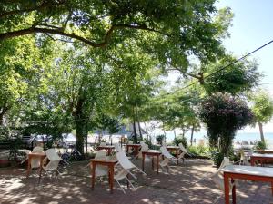 a group of tables and chairs under some trees at PINAR OTEL in Amasra