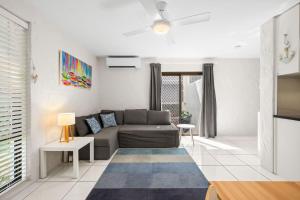 a living room with a couch and a table at La Costa Del Sol in Marcoola