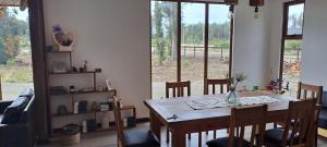 a dining room with a table and chairs and a window at Casa Torres in El Cardonal