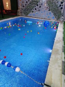 a swimming pool with balls in the water at سما المزرعة in Amman