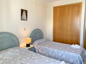 ein Hotelzimmer mit 2 Betten und einem Schrank in der Unterkunft MIAMI Playa de Gandía - Alquiler solo familias in Playa de Gandia