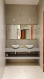 聖米格爾－杜戈斯托蘇的住宿－Casa Madá，一间带两个盥洗盆和大镜子的浴室