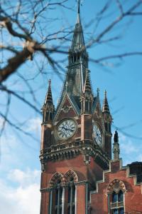 a building with a clock tower on top of it at London Central Budget Rooms in London