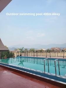 a swimming pool at a resort with mountains in the background at Downtown Vang Vieng Hotel in Vang Vieng