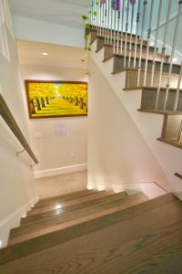 a staircase with a painting on the wall at Balaclava Park House close UBC and Downtown in Vancouver