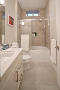 a bathroom with a toilet and a sink and a shower at Balaclava Park House close UBC and Downtown in Vancouver