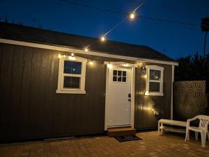 a house with a white door and lights on it at Chic Parisian Guest House in Phoenix