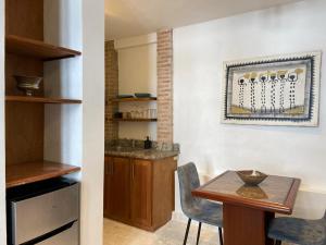 a kitchen with a table and a dining room at Paseo Colonial - Sanctuary #2 in Santo Domingo