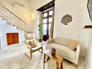 a living room with a couch and a chair at The Sanctuary in Santo Domingo